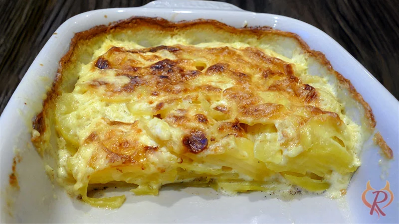 Kartoffelgratin im "Anschnitt", mit einem Pfannenwender geteilt und schon 2 Portionen aus der Form genommen.